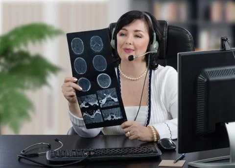 Portrait of remote GP looking at tomography image Foto stock