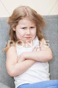 Portrait of resentful caucasian young girl with arms folded Stock Photos