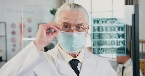 Portrait of respected high-skilled intelligent grey-haired male doctor in Stock Footage 160419615