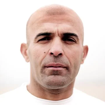 A portrait of a runner on the beach on a overcast day. Stock Photos