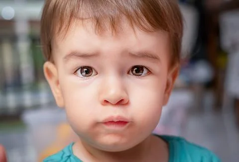 Portrait of the  sad child looking at the camera close Stock Photos
