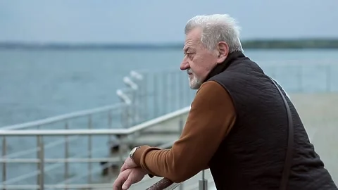 Portrait of sad lonely elderly man by the sea Stock Footage 157237621