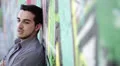 portrait sad man is crying because of his problems against a wall with murals HD Footage