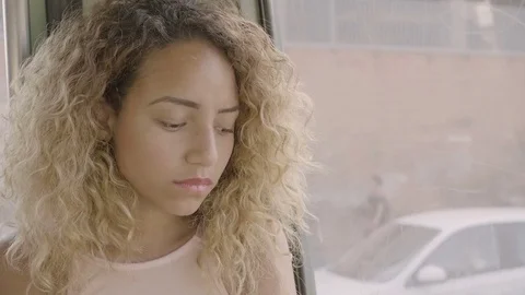 Portrait of a sad woman alone on the bus going in the town Stock Footage
