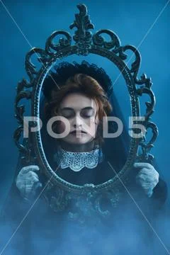 Portrait of a sad woman with closed eyes in a black veil in an old vintage fr Stock Photos