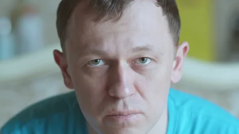 Portrait of a sad young man with gray eyes, looking at the camera, selective Stock Footage 163582445