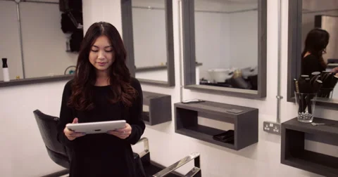 Portrait of a salon manager working on her digital tablet. Shot on RED Epic. Stock Footage 59671634