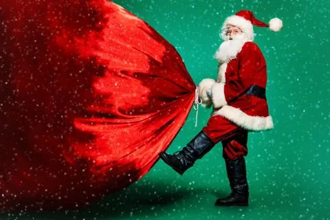A portrait of Santa Claus with a huge gift bag. Merry Christmas and Happy New Stock Photos
