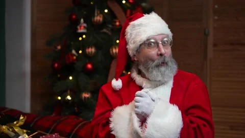 Portrait of Santa Claus looking at camera listens attentively and makes a thumbs Stock Footage 145401085