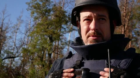 Portrait of a sapper in uniform, in a bulletproof vest and a helmet. In the Stock Footage 219810989