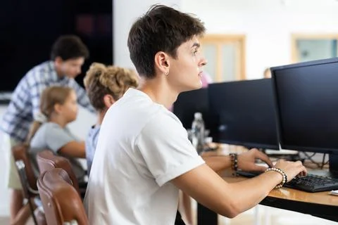 Portrait of satisfied student at computer in university computer lab Stock Photos