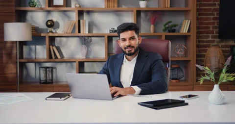 Portrait of Satisfied Young Man working with Laptop and smiling at the camera Stock Footage 220136286