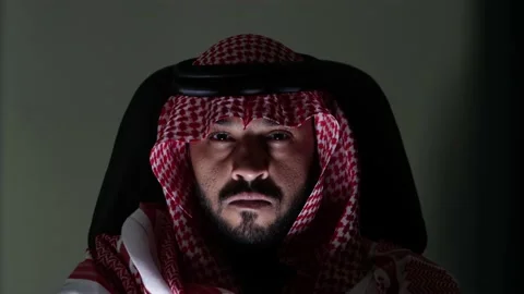 Portrait of Saudi Man On His Disk Working On His Computer Between Two Screen Stock Footage 236496932