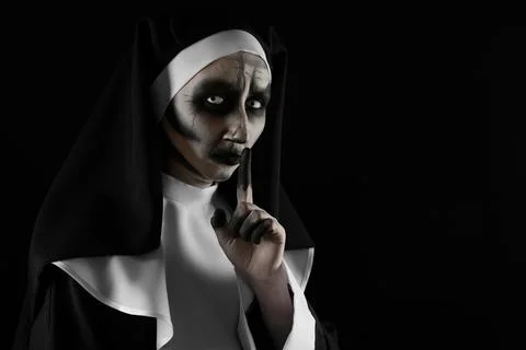 Portrait of scary devilish nun on black background, space for text. Halloween Stock Photos
