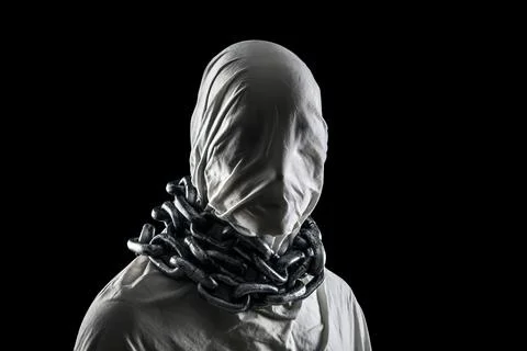 Portrait of a scary ghost with chains isolated on black background Stock Photos