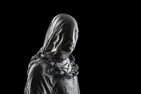 Portrait of a scary ghost with chains isolated on black background 스톡 사진