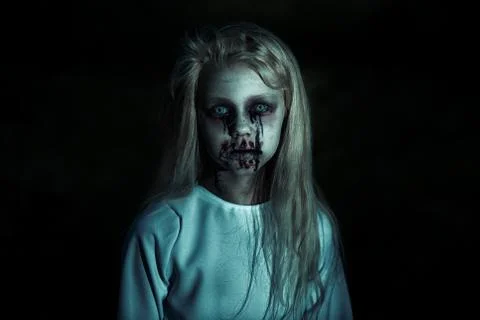 A portrait of a scary pale girl from a horror film in the forest. Zombie, hal Stock Photos