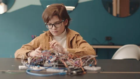 Portrait of School Kid Constructing Robot Video stock 153466520
