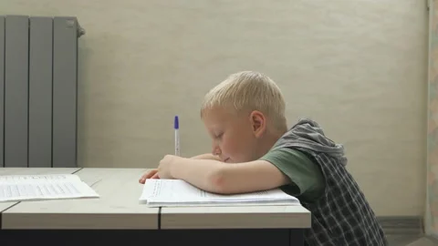 Portrait school kid siting on table doing homework, home schooling Stock Footage 171080124