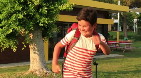 Portrait of a schoolboy with backpack smiling to a camera 2 Stock Footage 66477198