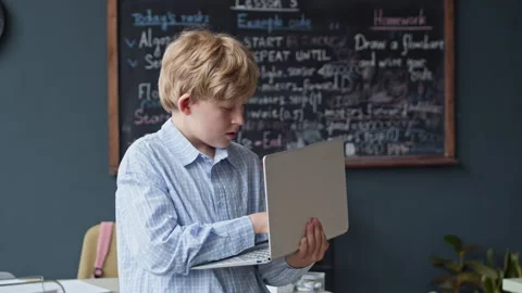 Portrait of Schoolboy Coding on Laptop in Robotics Lesson Stock Footage 339193107
