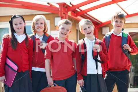 Portrait Of Schoolchildren Outside Classroom Carrying Bags Stock Photo ...