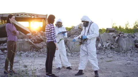 Portrait scientists in protective suits and masks and dosimeter ,measure Stock Footage 110443418