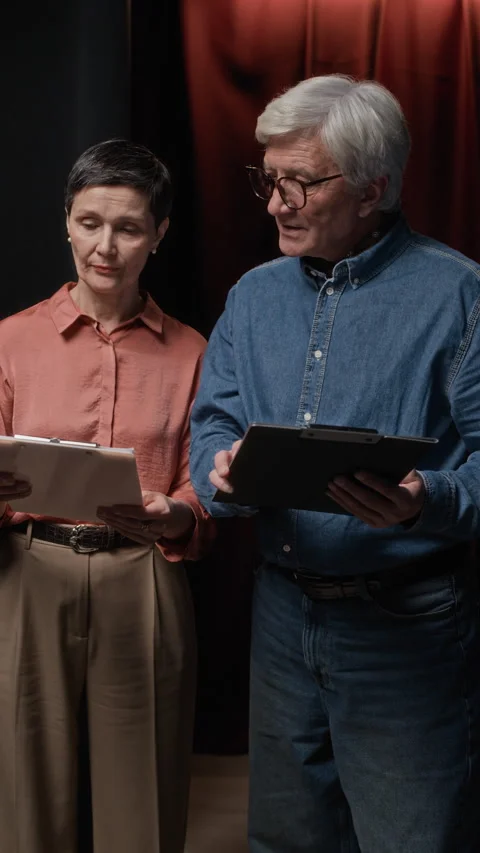 Portrait of Senior Director Discussing Script with Female Screenwriter Stock Footage 311569641