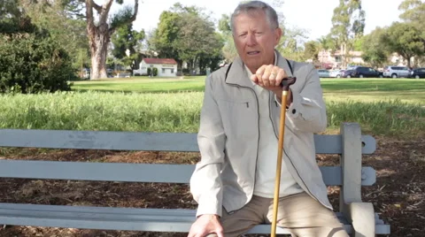 Portrait of a Senior Elderly Man with Cane Sitting on a Park Bench Vídeo Stock 48340260