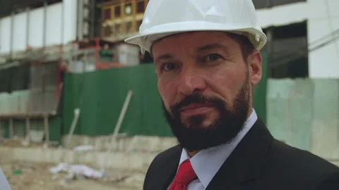 Portrait of a senior engineer with a beard, a builder at a construction site Video stock 162335319