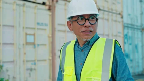 Portrait of a senior engineer in a reflective vest adjusting his safety helmet Video stock 309545971