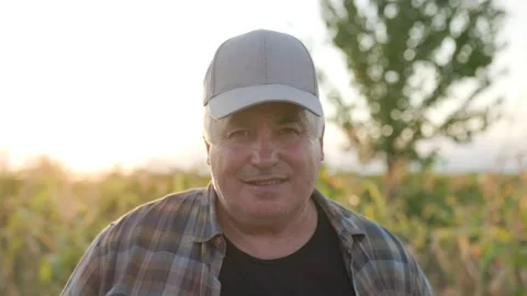 Portrait of a Senior Farmer in Cap, Posed in Agricultural Field Video stock 282742596