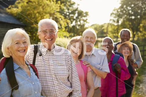 Portrait Of Senior Friends Hiking In Countryside Stock Photos