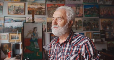 Portrait of the senior man with beard looking aside and then smiling at camera Stock Footage 123503433