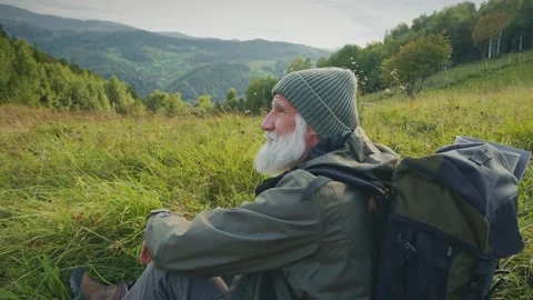 Portrait of a Senior Man with a Camping Backpack. Hiking in The Mountains. Stock Footage 163170460