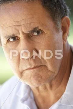 Portrait Of Senior Man Frowning At The Camera Stock Photos