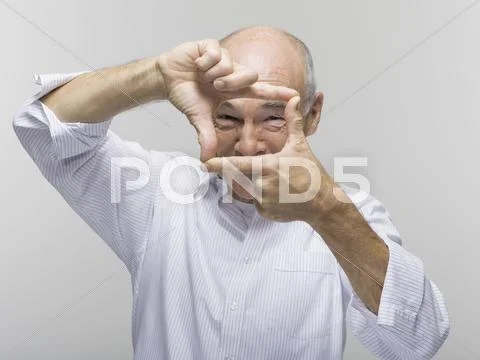 Portrait of a senior man, gesturing with one hand above the other Stock Photos