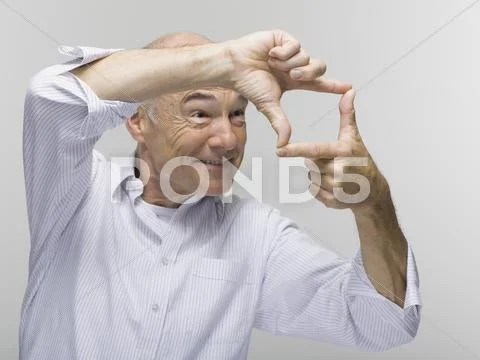 Portrait of a senior man, gesturing with one hand above the other Stock Photos