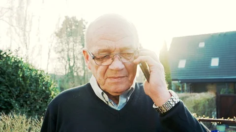 Portrait of senior man having conversation on smart phone outside Stock Footage 104606309