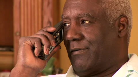 Portrait of senior man indoors talking on cell phone Stock Footage