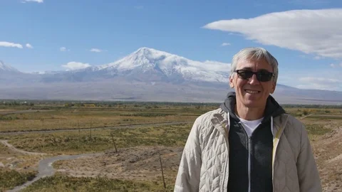 Portrait of senior man looking at camera face medium shot outdoors in mountains Stock Footage 82203659