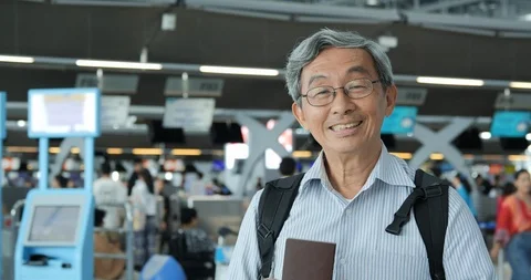 Portrait of senior man smiling at the flight timetable background in airport. Stock Footage 116550873