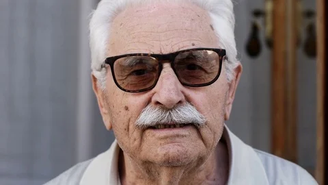 Portrait of senior man with sunglasses looking at camera Stock Footage 80683073