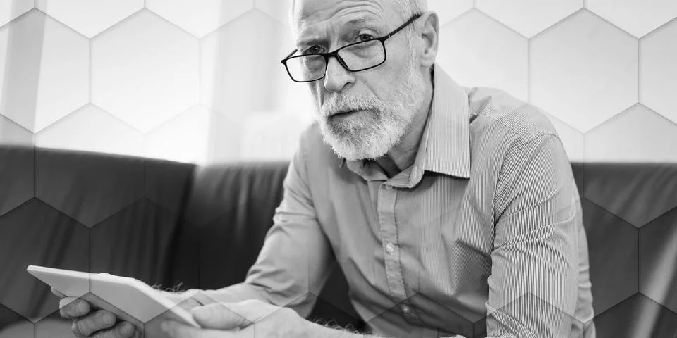 Portrait of senior man using a tablet, geometric pattern Stock Photos