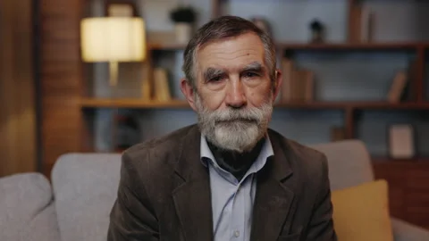 Portrait of Senior Old Gray-haired Man Sitting in the Living Room. Calm Mature Stock Footage 234048440