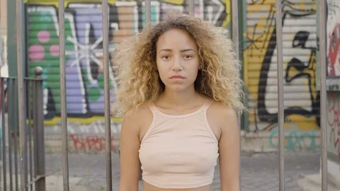 Portrait of a serious and thoughtful Hispanic girl in a suburban area Stock Footage 80656111