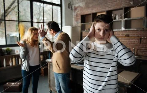Portrait of serious boy while looking straight at camera Stock Photos