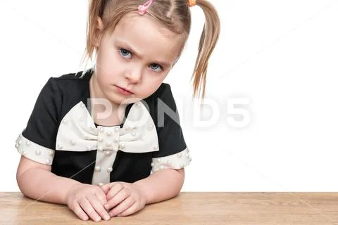 Portrait of serious child at a desk Stock Photos