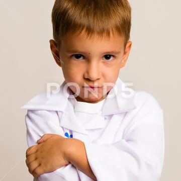Portrait of serious child in the doctor's suit Stock Photos