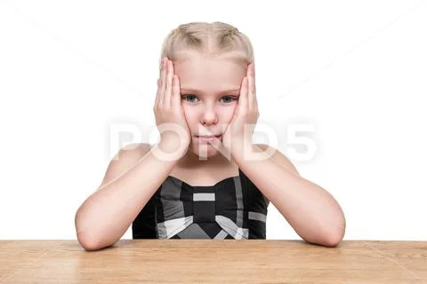 Portrait of serious child at the table Stock Photos